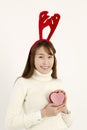 Young beautiful asian woman wearing Christmas antlers