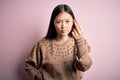 Young beautiful asian woman wearing fashion and elegant sweater over pink solated background Doing Italian gesture with hand and