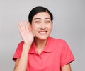 Young beautiful asian woman wore pink t shirt, Showed Listen expression , on gray background