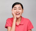 Young beautiful asian woman wore pink t shirt, Showed shy expression ,awestruck on gray background