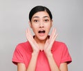 Young beautiful asian woman wore pink t shirt, Showed surprised expression , on gray background