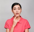 Young beautiful asian woman wore pink t shirt, Showed Surprised and Thinking expression , on gray background Royalty Free Stock Photo