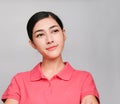 Young beautiful asian woman wore pink t shirt, Showed thinking expression , on gray background Royalty Free Stock Photo