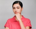 Young beautiful asian woman wore pink t shirt, Showed Thinking and serious expression , on gray background Royalty Free Stock Photo