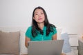 Young beautiful Asian woman working with laptop on bed -  lifestyle home portrait of young attractive and happy Chinese student Royalty Free Stock Photo
