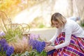 Young beautiful Asian women gardener take care of her flower in backyard