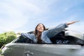 Young beautiful asian women getting new car. She relaxing out of window in a car - Freedom car travel concept Royalty Free Stock Photo