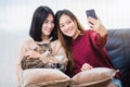 Young beautiful Asian women lesbian couple lover using smartphone selfie cute cat pet in living room at home with smiling face.