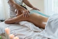 Young beautiful Asian woman relaxing in the spa massage and having salt scrub massage at back. healthy lifestyle and relaxation c Royalty Free Stock Photo