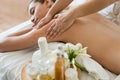 Young beautiful Asian woman sleep relaxing in the Oil spa massage in salon. Select focus hand of masseuse. Royalty Free Stock Photo