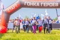 Young beautiful athletic people starts on a traditional race of heroes. Text in Russian: Start, race of heroes, throw Royalty Free Stock Photo