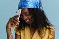 Young beautiful attractive long-haired curly smiling african woman with phone Royalty Free Stock Photo