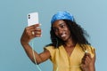 Young beautiful attractive long-haired curly smiling african woman taking selfie Royalty Free Stock Photo