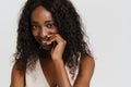 Young beautiful attractive long-haired smiling african woman touching her lip Royalty Free Stock Photo