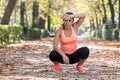 Attractive sport woman in runner sportswear breathing gasping and taking a break tired and exhausted after running workout on Autu