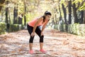 Attractive sport woman in runner sportswear breathing gasping and taking a break tired and exhausted after running workout on Autu Royalty Free Stock Photo