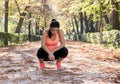 Attractive sport woman in runner sportswear breathing gasping and taking a break tired and exhausted after running workout on Autu