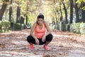 Attractive sport woman in runner sportswear breathing gasping and taking a break tired and exhausted after running workout on Autu