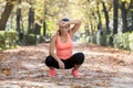 Attractive sport woman in runner sportswear breathing gasping and taking a break tired and exhausted after running workout on Autu Royalty Free Stock Photo