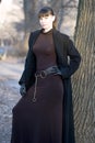 Young beautiful attractive woman in dress and coat