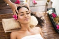 Young beautiful Balinese woman receiving head massage