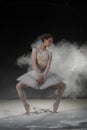 Young beautiful ballerina dancing in flour in the studio Royalty Free Stock Photo