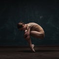 Young beautiful ballet dancer in beige swimsuit