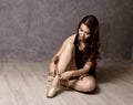 Young beautiful ballet dancer in pointe shoes, dancing in a gray background Royalty Free Stock Photo