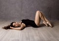 Young beautiful ballet dancer in pointe shoes, dancing in a gray background Royalty Free Stock Photo