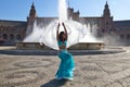 A young and beautiful belly dancer dancing in a square. She is dressed in light blue with a white veil in her hands. World Royalty Free Stock Photo