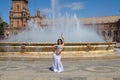 A young and beautiful belly dancer dancing in a square. She is dressed in light blue with a white veil in her hands. World Royalty Free Stock Photo