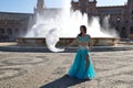 A young and beautiful belly dancer dancing in a square. She is dressed in light blue with a white veil in her hands. World Royalty Free Stock Photo