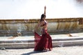 A young and beautiful belly dancer dancing in a square. She is dressed in light blue with a white veil in her hands. World Royalty Free Stock Photo