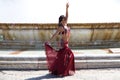 A young and beautiful belly dancer dancing in a square. She is dressed in light blue with a white veil in her hands. World Royalty Free Stock Photo