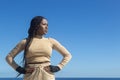 Young beautiful black afro girl prepared to train with hands on waist and background of sea and blue sky, attitude and Royalty Free Stock Photo