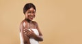 Young Beautiful Black Female With Perfect Skin Applying Moisturizing Body Lotion Royalty Free Stock Photo