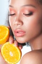 Young beautiful black girl with clean perfect skin with lemon close-up