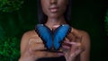 Young and beautiful black model exotic look with bright blue butterfly Royalty Free Stock Photo