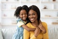 Young Beautiful Black Woman And Her Cute Preteen Daughter Posing At Home Royalty Free Stock Photo