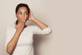 Young beautiful black woman wearing casual t-shirt standing over white background afraid and shocked, surprise and amazed Royalty Free Stock Photo