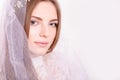 Young beautiful blond fiancee portrait with white veil/