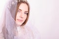 Young beautiful blond fiancee portrait with white veil.