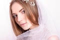 Young beautiful blond fiancee portrait with white veil.