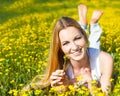 Young beautiful blond girl laying on the daisy flowers field. Outdoor portrait Royalty Free Stock Photo