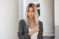 Young beautiful blond girl in vintage gray jacket Royalty Free Stock Photo