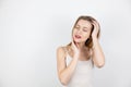 Young beautiful blond woman with closed eyes looks happy with her skin touching her face standing on isolated white background, Royalty Free Stock Photo