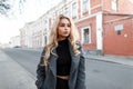 Young beautiful blond woman in a fashion gray jacket