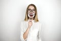 Young beautiful blond woman holding magnifier near her mouth isolated white background