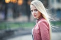 Young beautiful blond woman portrait posing in city street on sunset Royalty Free Stock Photo