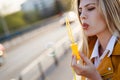 Young beautiful woman using bubble blower in the city Royalty Free Stock Photo